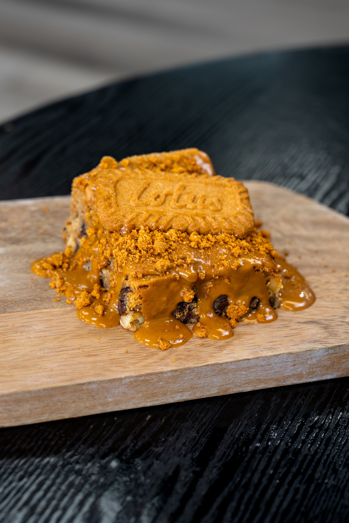 Biscoff cookie dessert topped with warm cookie butter and crumbs