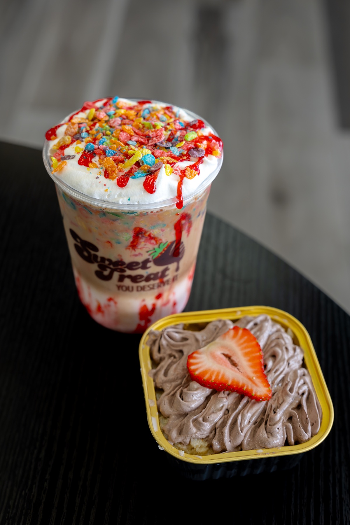 Sweet Treat fruit drink and tres leches dessert topped with a strawberry